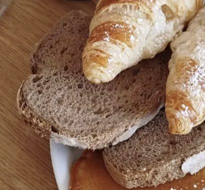 Torradas artesanais com croissants no fundo