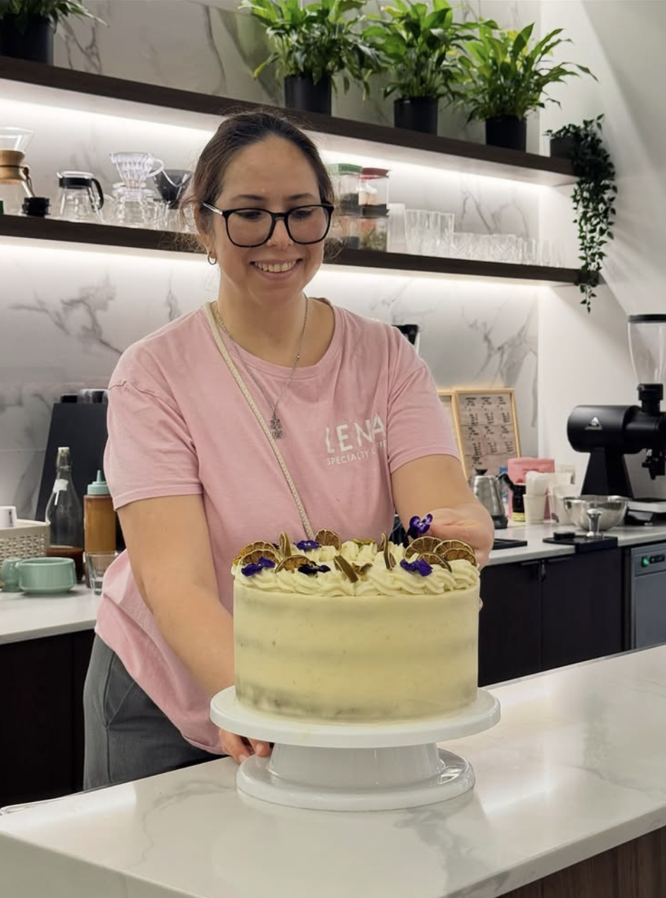 A LENA team member presenting a homemade cake